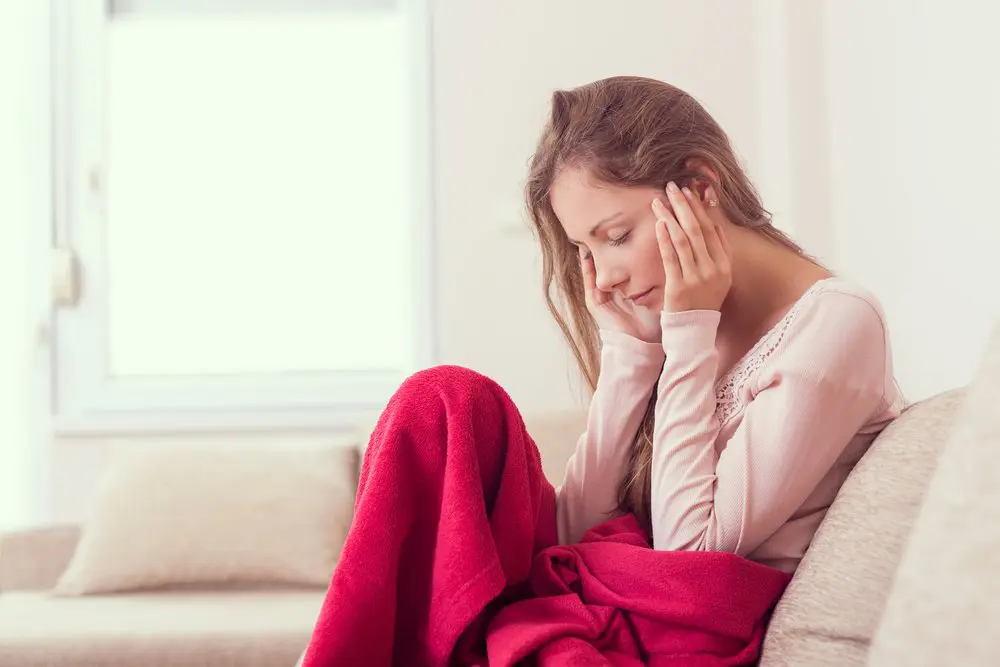 burbank woman with migraine on couch