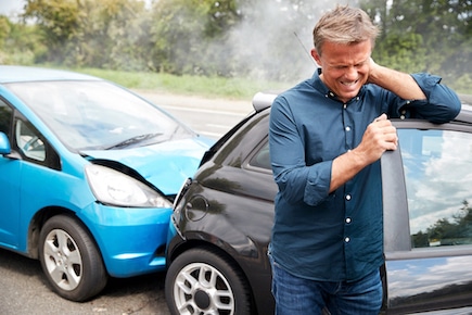 Man holding his neck due too an accident