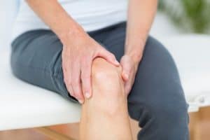 patient holding their knee