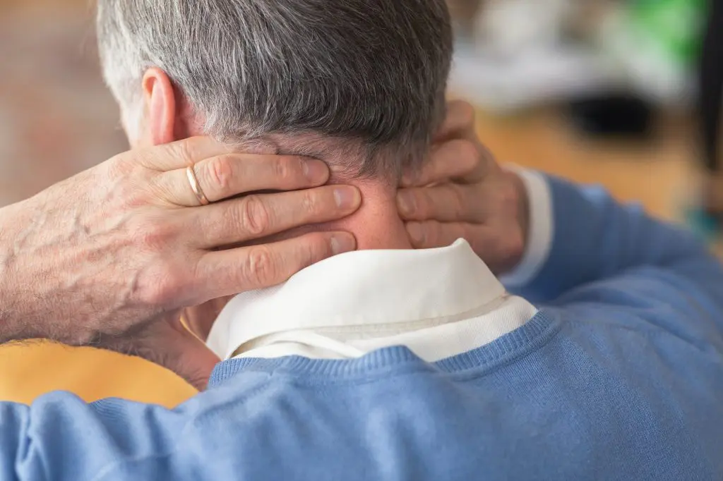 elderly man holding his neck due to pain