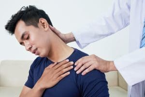 young man having his neck stretched by a chiropractor