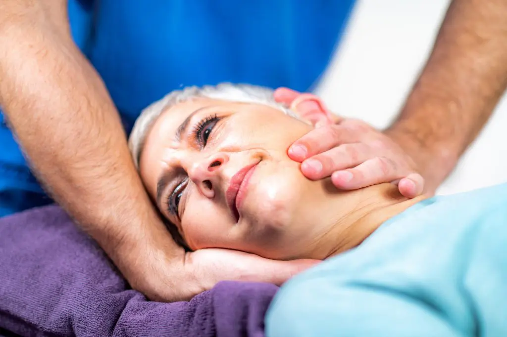 Chiropractor adjusting patients neck