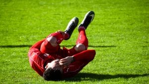 A football player having an injury in the field