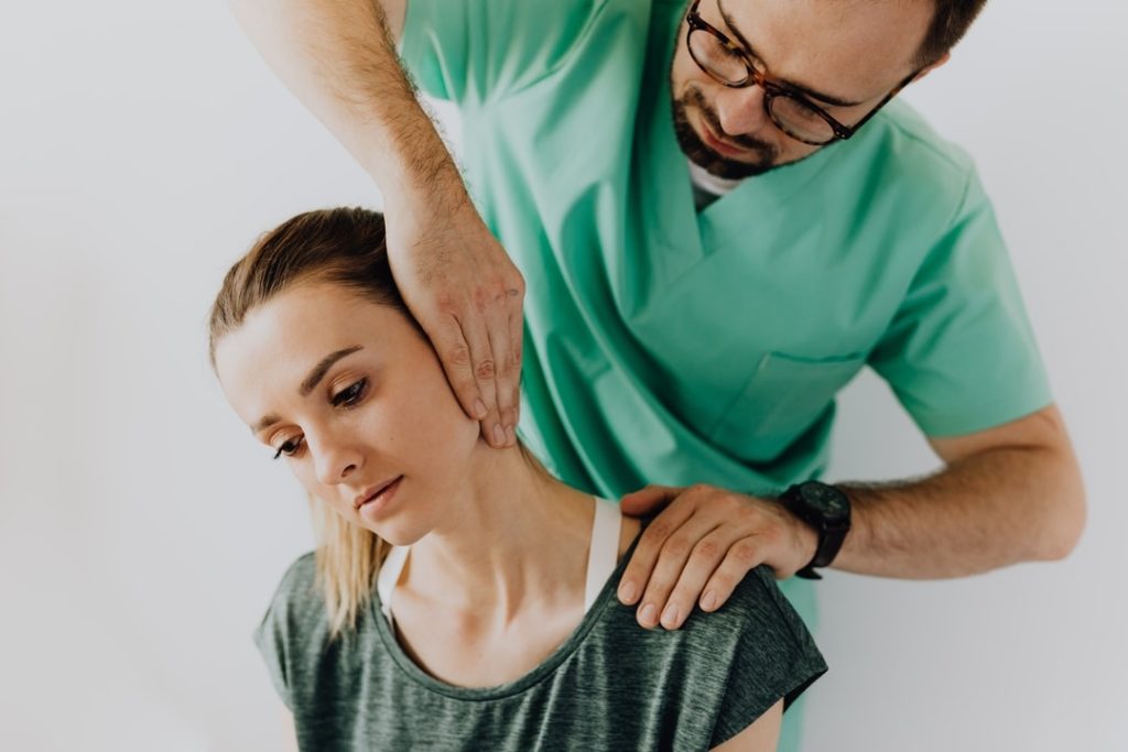 Chiropractor treating patient with jaw pain.