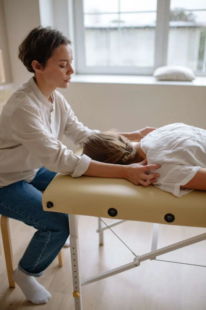 Chiropractor preparing a patient for EMS Therapy