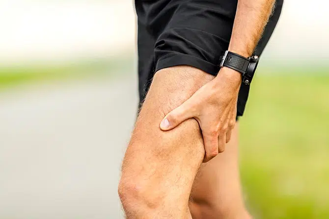 Runner holding his leg because of pain