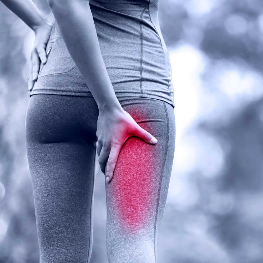 Runner holding her leg cause of sciatica leg pain