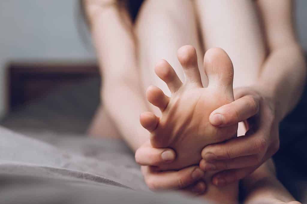 Young woman suffering from Neuropathy foot pain 