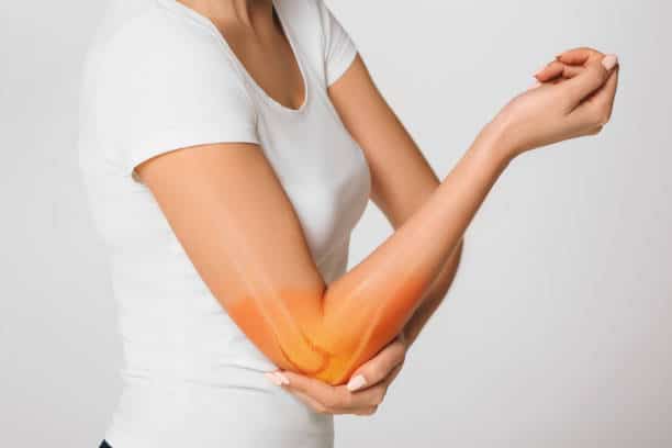 woman suffering pain in the elbow.