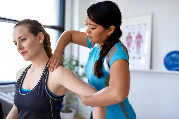 Physiotherapist doing some sports massage to an athlete patient.