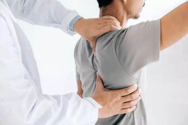 Chiropractor doing some shoulder adjustment to the patient.