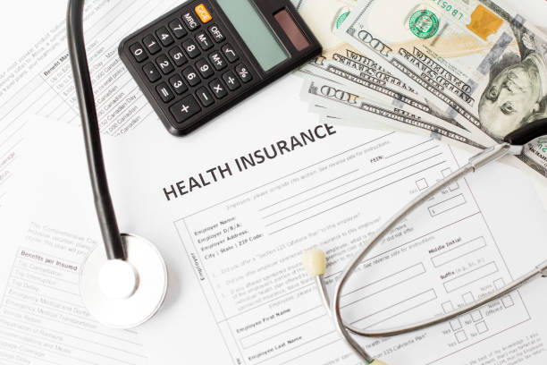 health insurance policy banknote and stethoscope.