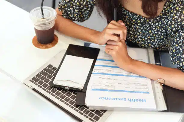 Patient checking her blue cross blue shield chiropractic health insurance coverage online.