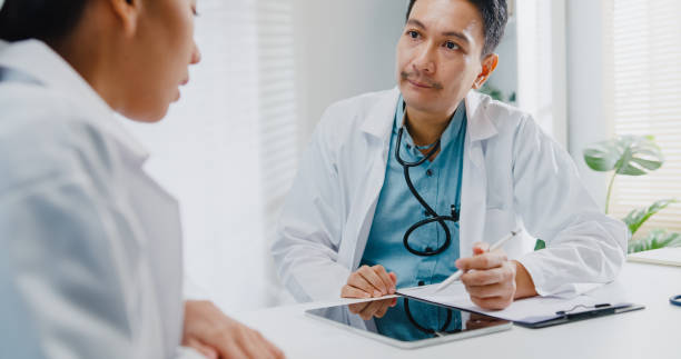 Chiropractor discussing the health insurance limitation to the patient.