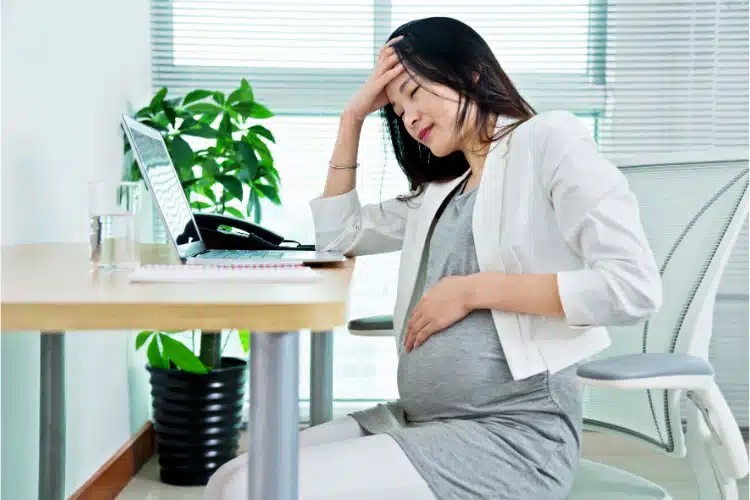 Pregnant woman having headache.