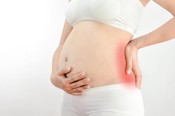 Pregnant woman having back pains.