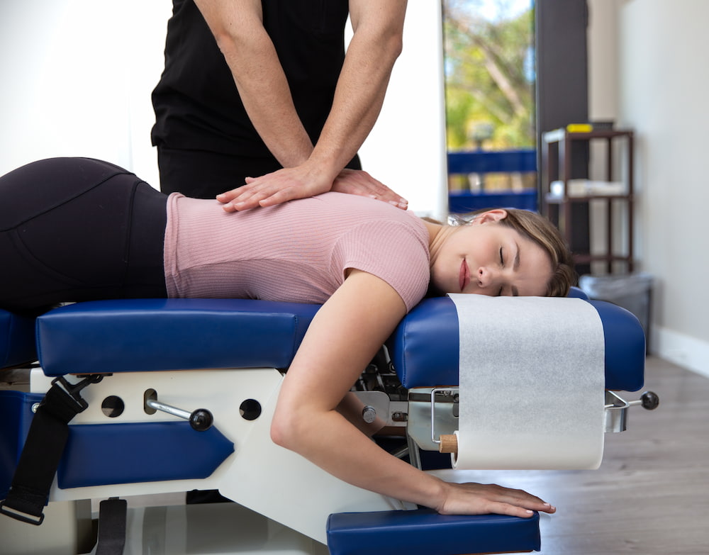 Dr. Simian performing chiropractic care treatment at Burbank Clinic.