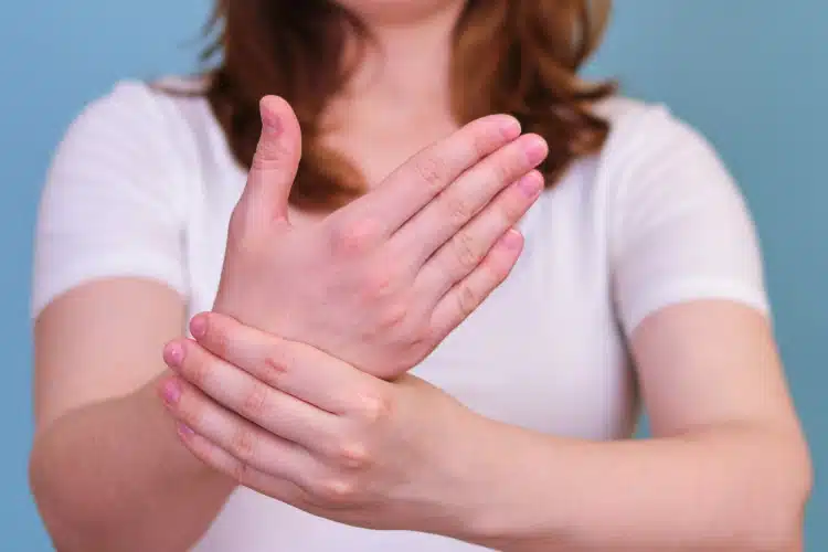 Pregnant woman showing swollen wrist during pregnancy.