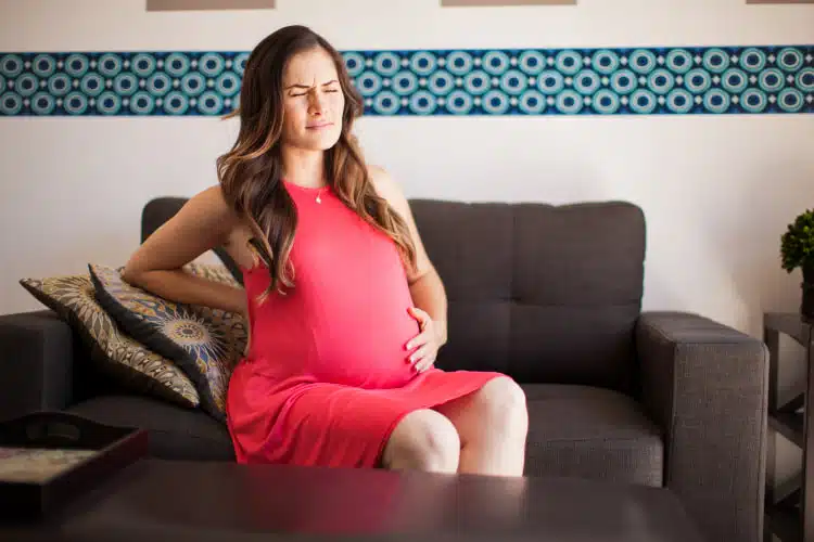 Pregnant woman suffers from Back Pain and Pelvic Discomfort during pregnancy.