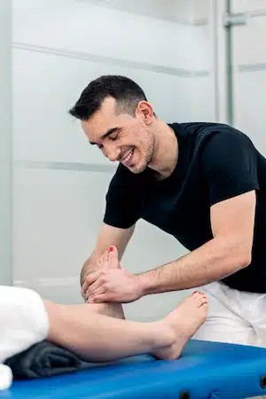 Physiotherapist Massaging Woman's Feet with plantar fasciiitis