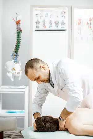 Physiotherapist doing treatment on a man with vertigo at clinic