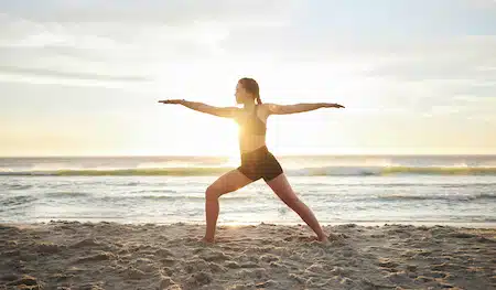 woman doing yoga and meditation at the beach