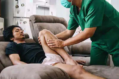 injured man receiving chiropractic care for knee pain treatment in burbank