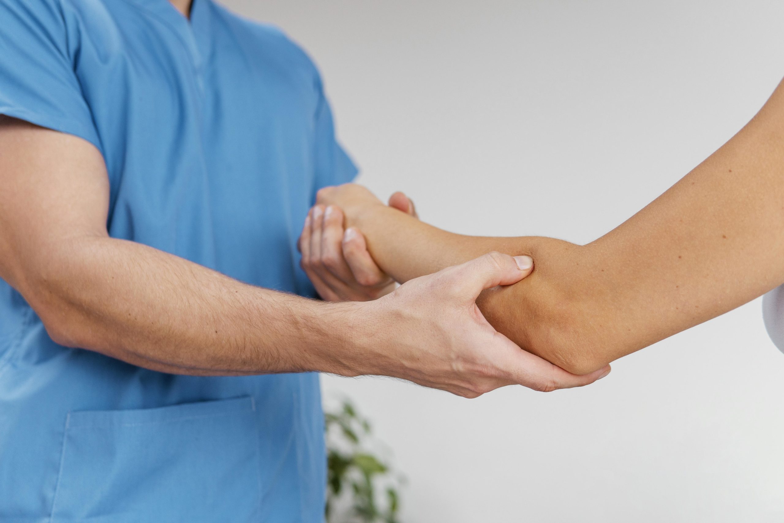 doctor assisting patient with massage treatment for carpal tunnel