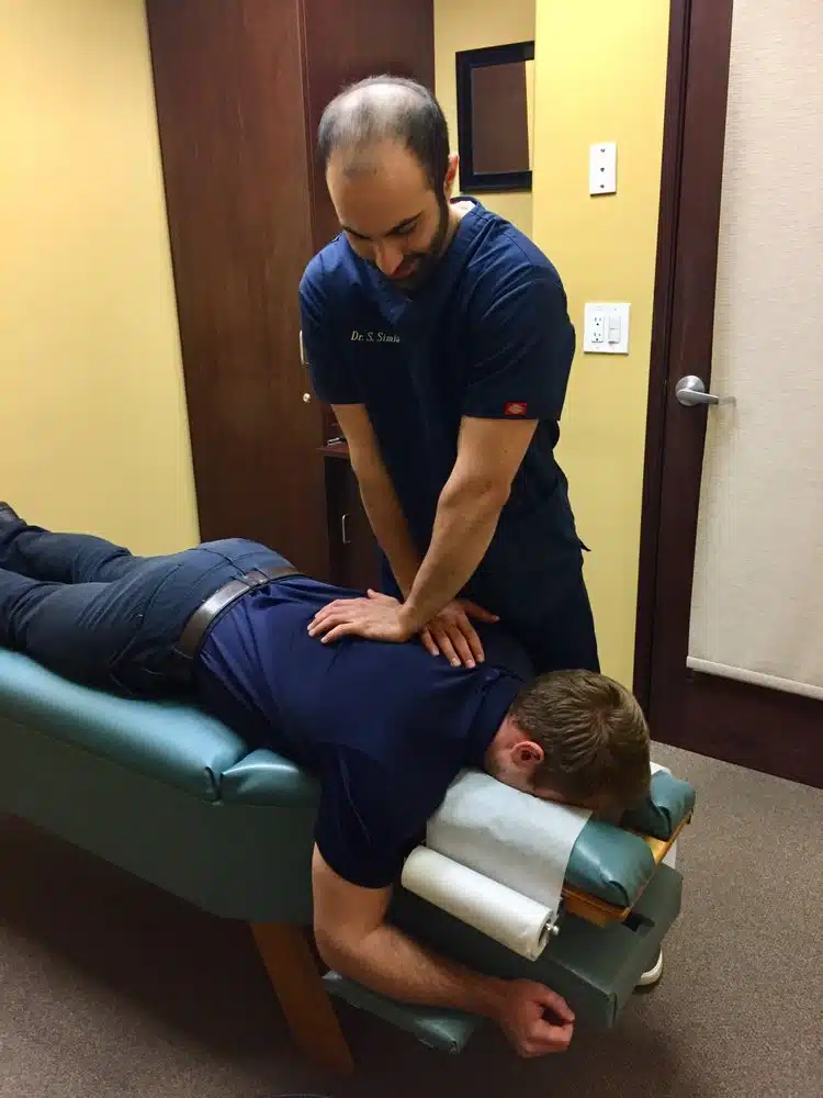 A-man-with-a-back-pain-having-a-chiropractic-care