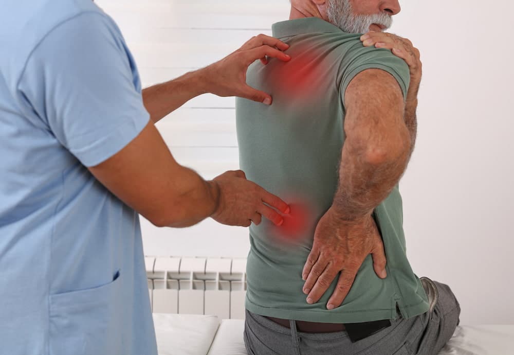 An old man with a back pain