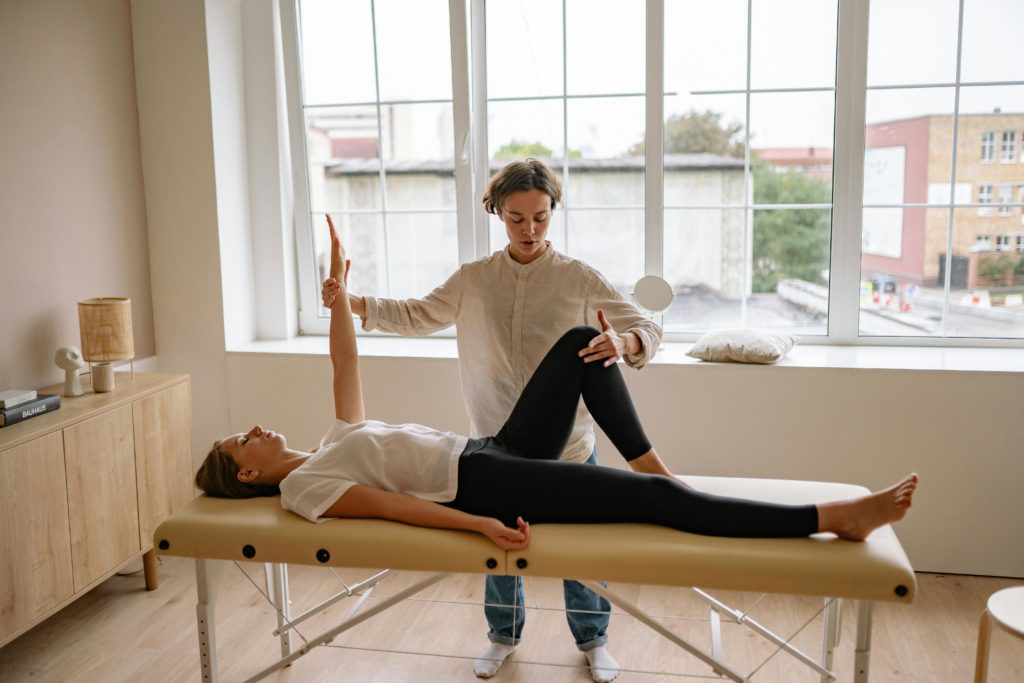 woman receiving chiropractic care and massage therapy for reduced stress and enhanced overall well being