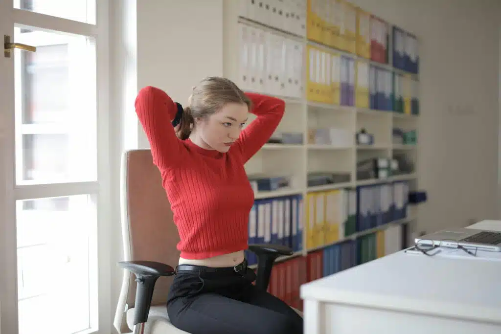 Female employee tying hair in office